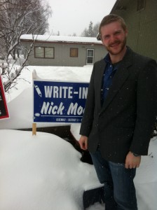 Nick Moe stands beside a campaign sign in his yard at his home in 'Old Spenard'.