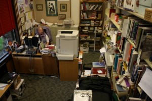 Library Director Sarah Bell works in her office at Kettleson Memorial Library on Wednesday, Sept. 26. Her office has become defacto storage for a lot of the library's equipment. (Photo by Ed Ronco/KCAW)