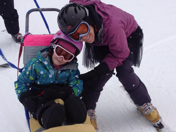 Leah and her daughter Anna downhill skiing with Challenge Alaska.