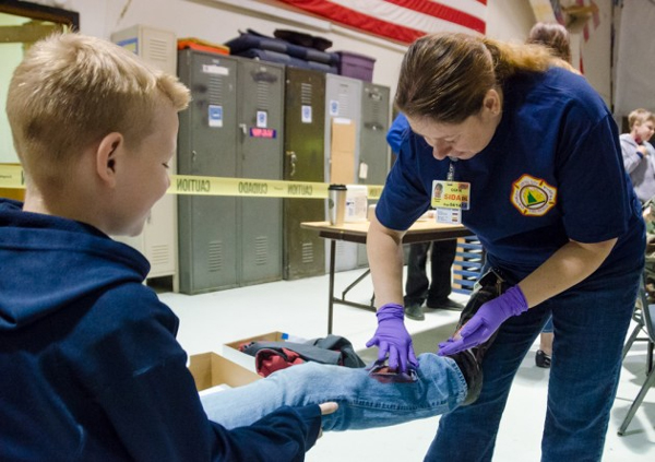 A young victim gets his leg “broken.” (Photo by Heather Bryant/KTOO)