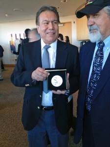 Robert "Jeff" David Jr., left, holds the silver medal awarded to his dad, who the family just learned was a code talker. David, of Haines, traveled to Washington, DC with former legislator Bill Thomas. Photo by Liz Ruskin, APRN - Washington DC.