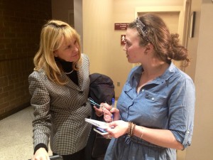 Tegan Hanlon, with the Anchorage Daily News, interviews CH2M Hill Vice President Stacey Jones outside Assembly chamber Tuesday evening.
