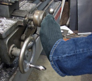 Mark Partido was born with arthrogryposis, which limits the use of his lower arms and hands, so he operates the lathe with his toes. Photo by Robert Woolsey, KCAW - Sitka.