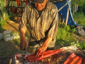 Cutting salmon for drying in Nikolai. Courtesy Alaska Department of Fish and Game.