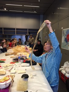 Elaine Kingeekuk shows off different types of guts to a group of elementary school students at the Anchorage Museum. HIllman/KSKA