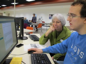 Micah Williams gets help from Navigator Joan Fisher at the Loussac Library. Photo Credit: Annie Feidt