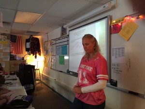 Math teacher Piper Jones listens to her students before distributing a quiz.