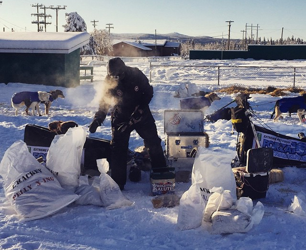 Lance Mackey cooks up a snack for his dogs. (Photo by Emily Schwing, KUAC - Fairbanks)