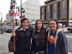 Tenth graders Sonja Barnard, Salem Collins, and Tessa Meeno protest education budget cuts. Hillman/KSKA