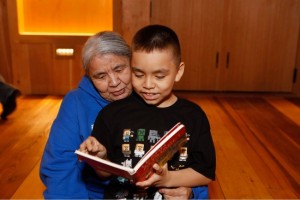 Betty Ann Samato reads a book with her grandson Bryson Stepetin at a Baby Raven Reads family night. (Photo by Brian Wallace/Courtesy Sealaska Heritage Institute)