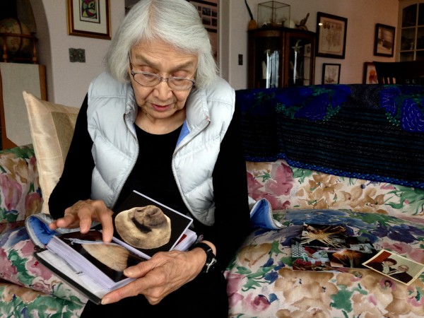 Delores Churchill shows a photo album of her weaving during a recent visit to Petersburg. Photo/Angela Denning