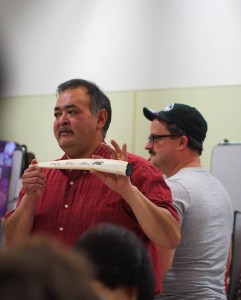 Middy Johnson shows off a walrus tusk etched by Gary Sockpick of Shishmaref. Photo: Zachariah Hughes, KSKA.
