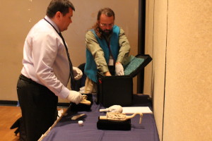 Eric Hollinger and Robert Starbard put away the replicas. Photography can be a sensitive subject when it comes to shamanic objects. These were photographed with permission. (Photo by Elizabeth Jenkins/KTOO)