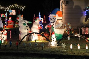Snowmen warming up by the fire in the Romine’s yard. (Brielle Schaeffer/KCAW photo)
