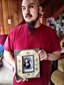 Randy LaRose holds a picture of his sister, Michelle Clark, an Alaska National Guard sergeant who died in 2011.