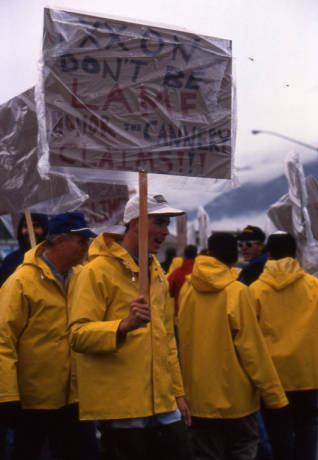 Seafood processors picketing and protest at Exxon's headquarters. Their signs read, "Exxon, don't be lame, honor the cannery claims." Photo: Alaska Office of the Governor. Accessed via Alaska Digital Archives.
