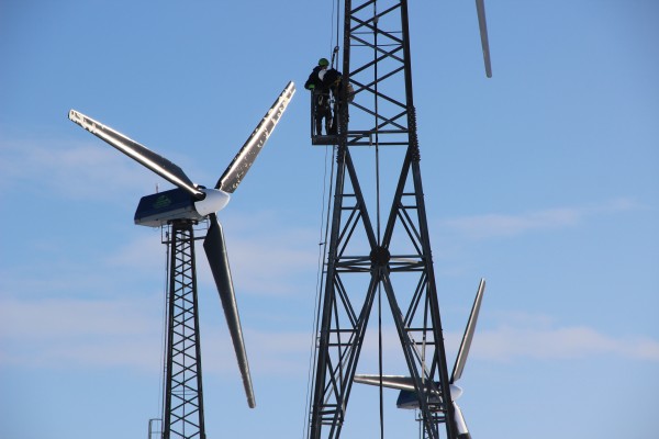 Patrick Boonstra, of Intelligent Energy Systems, and Kwigillingok wind tech Benny Daniel check a turbine after a blizzard the night before. Photo: Rachel Waldholz/APRN