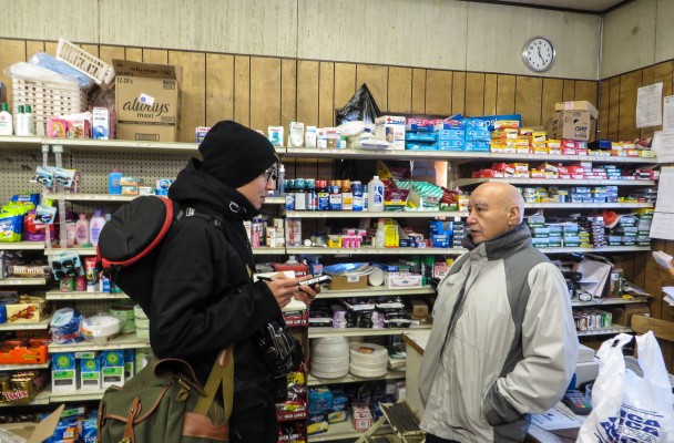 Brian Adams interviews Karl Ashenfelter at the White Mountain Native Store. (Photo by Laura Kraegel, KNOM - Nome)