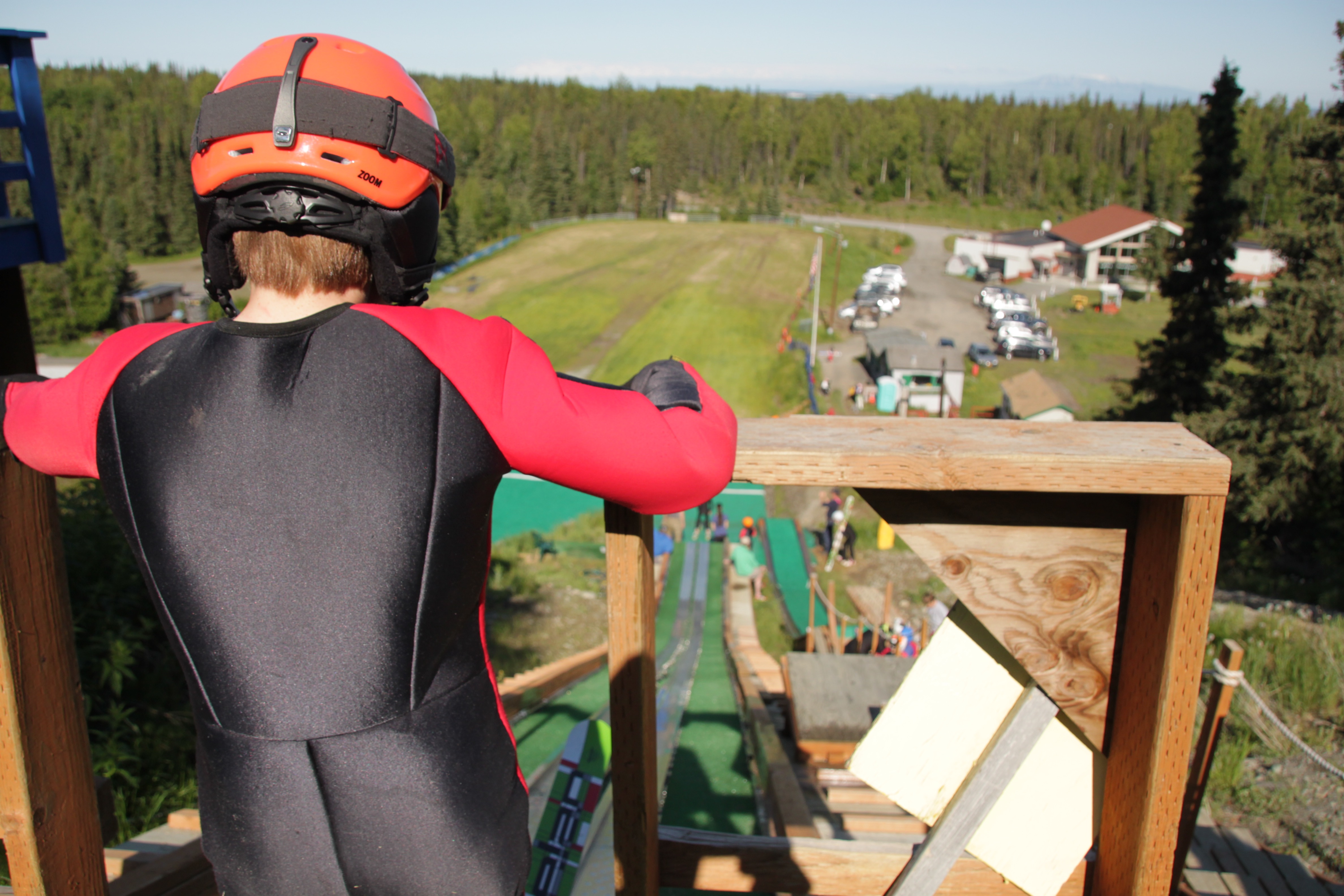 One of the skiers looks out at the ski jump facility from the top of the 40-meter hill. (Photo by Ammon Swenson, Alaska Public Media - Anchorage)