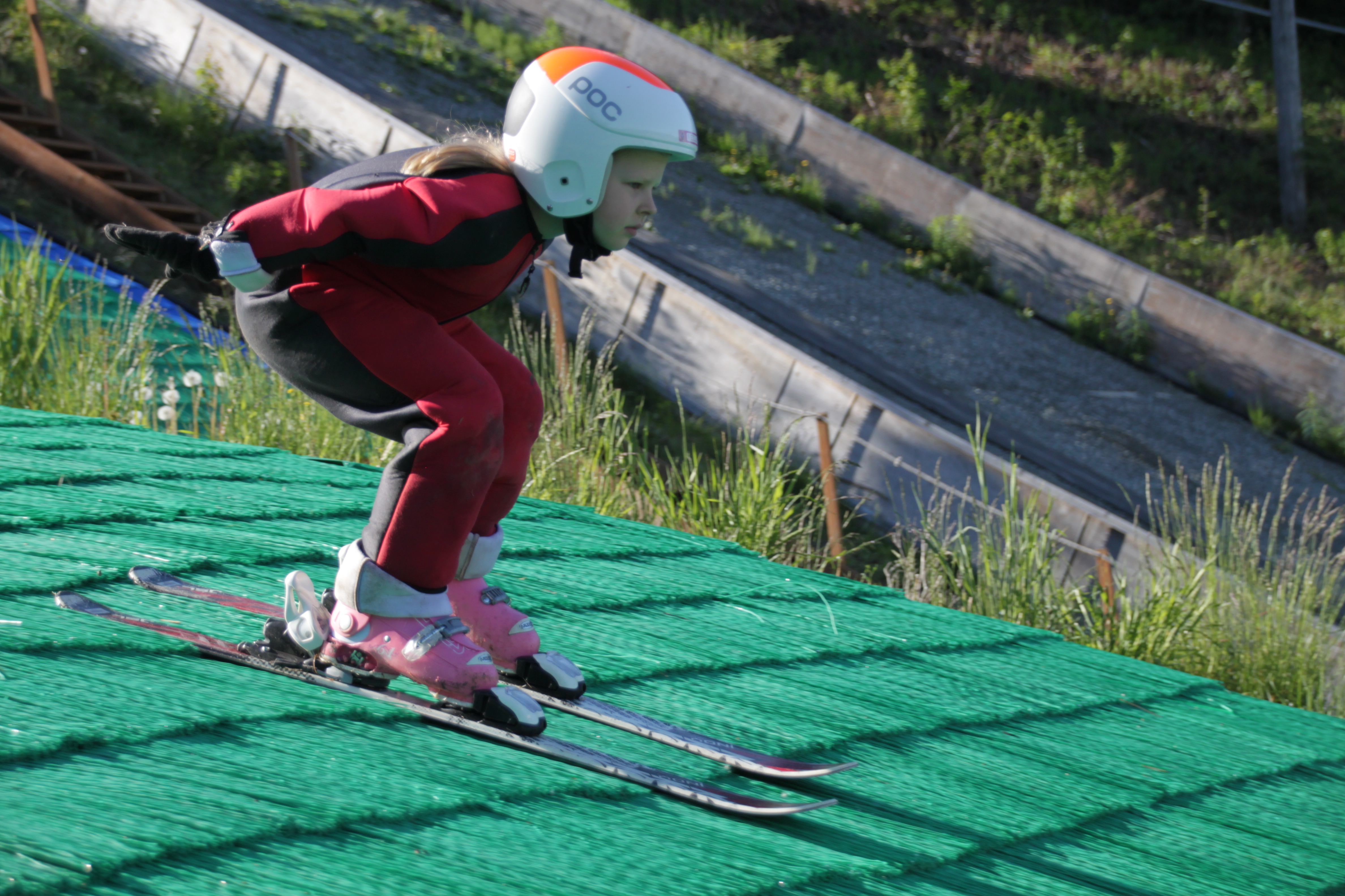 6-year-old Reilly Cooper skies down the 20 meter hill. (Photo by Ammon Swenson, Alaska Public Media - Anchorage)