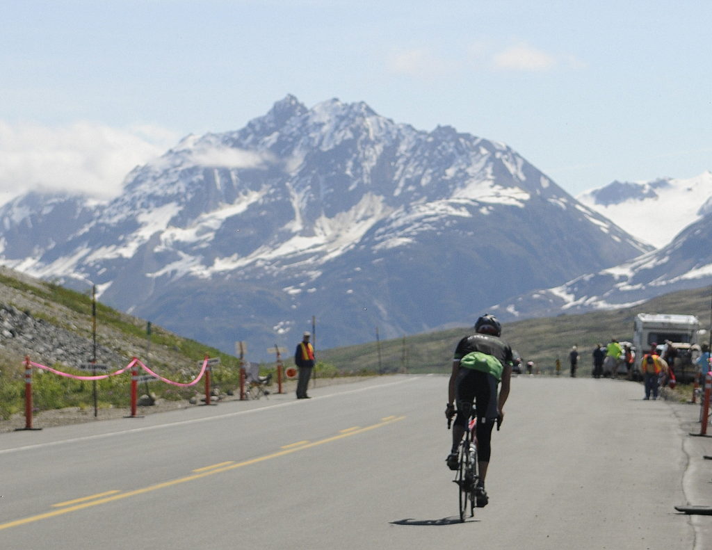 A solo rider crests the summit during Saturday’s Kluane-Chilkat International Bike Relay. (Photo by Jillian Rogers - KHNS - Haines)