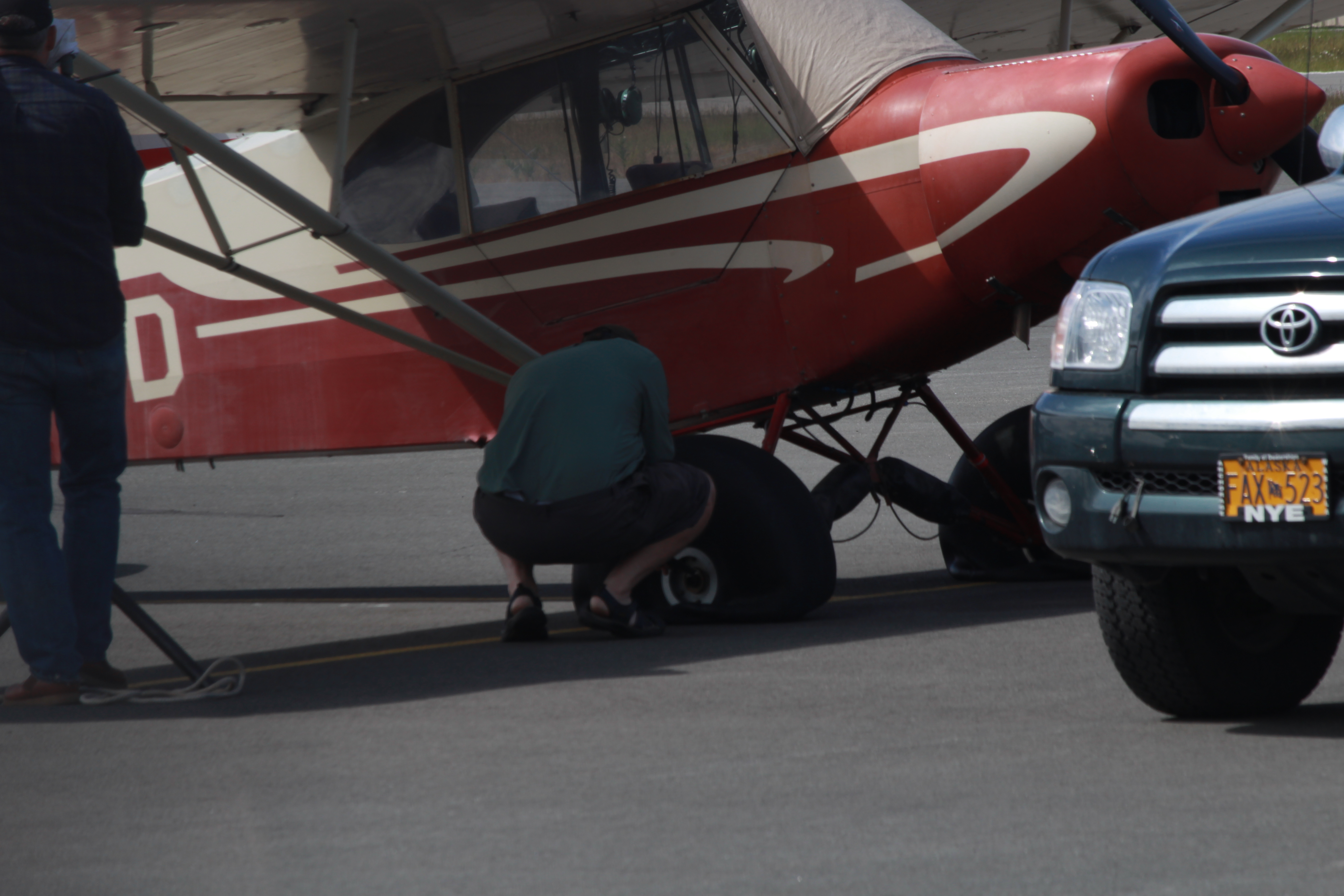 One of the victims of the tire slashings repairs his plane at Merrill Field (Photo by Wesley Early, Alaska Public Media - Anchorage)