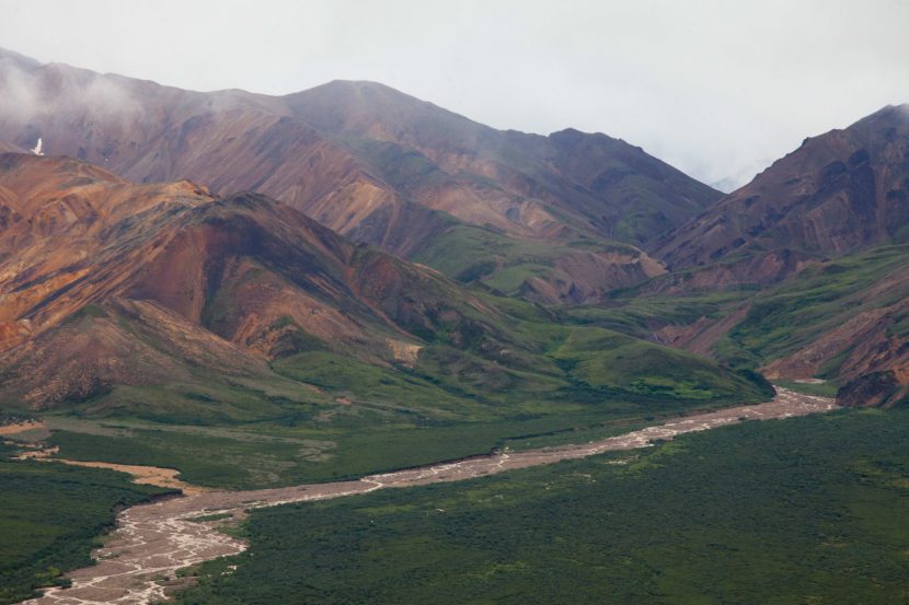 The colorful Polychrome Mountains emerge from the clouds on July 22, 2016, in Denali National Park. The mountains get their color from volcanic rock. The U.S. Geological Survey released the first updated geochemical atlas of Alaska in nearly 40 years. (Photo by Rashah McChesney, KTOO - Juneau)
