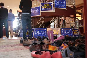 Piles of shoes at the entrance to a Democratic fundraiser for Dean Westlake and Zach Fansler, at the home of oil and gas attorney Robin Brena. The fundraiser was co-hosted by nine House Democrats and former U.S. Senator Mark Begich, among other. Photo: Rachel Waldholz/Alaska's Energy Desk