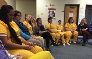 Women at Hiland Mountain Correctional Center listen to the songs they wrote together for their children. Hillman/Alaska Public Media)