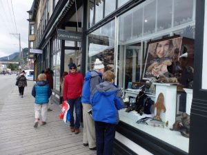 Tourists look in the window of Lynch and Kennedy Dry Goods in May 2016. Photo by Emily Files. 