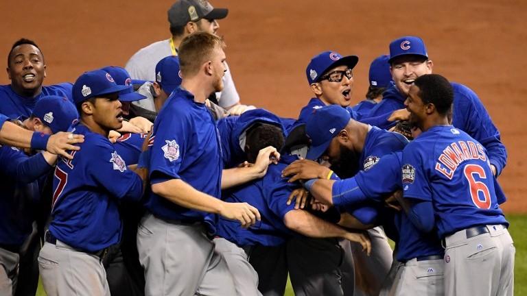 The Chicago Cubs celebrate after defeating the Cleveland Indians 8-7 in Game Seven of the 2016 World Series at Progressive Field on November 2, 2016 in Cleveland, Ohio. (Photo by Jason Miller/Getty Images/AFP)