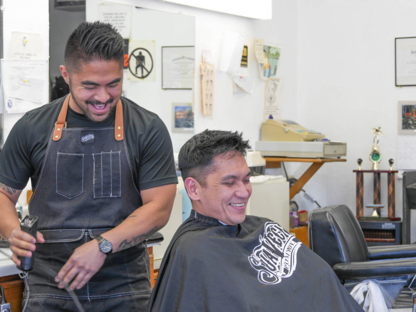Gerry Carrillo Jr. cuts David Mende’s hair. Gerry is the newest family member to work at Gerry’s Barbershop. (Photo by Lakeidra Chavis, KTOO - Juneau)