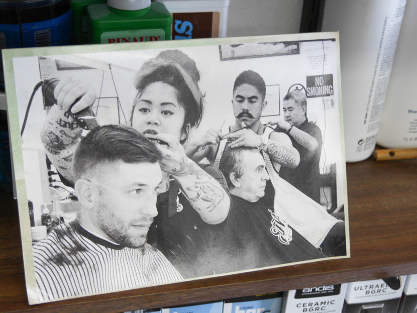 A photo of the Carrillo family sits on a shelf inside Gerry’s Barbershop. From left to right: Eva, Gerry Jr., and Gerry Sr. (Photo by Lakeidra Chavis, KTOO - Juneau)