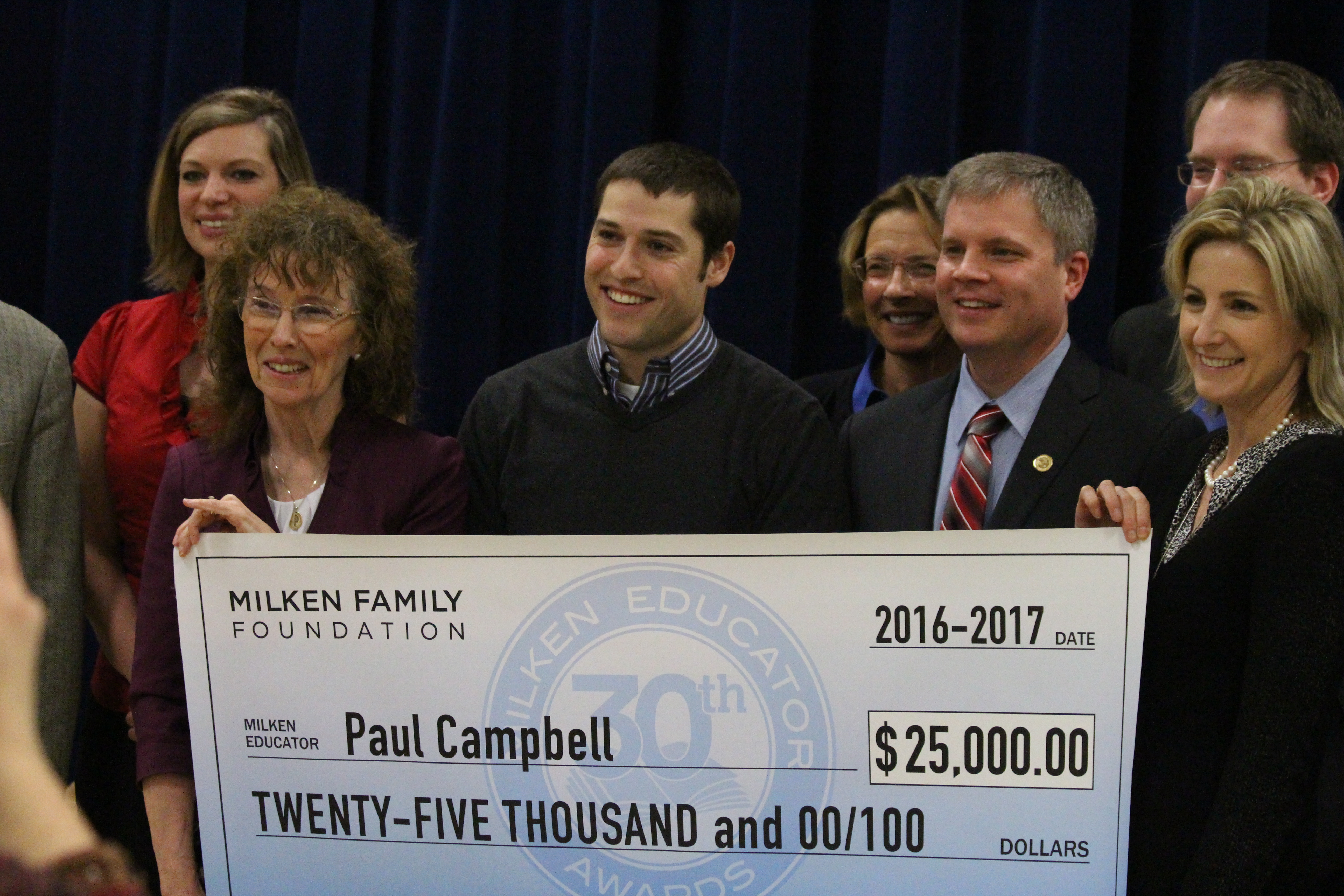 Paul Campbell holds his over-sized check for $25,000. (Photo by Wesley Early, Alaska Public Media - Anchorage)