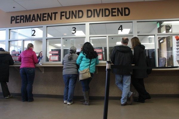 People waitiing in line at a counter at the PFD office