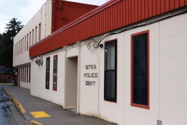 A beige building with a red metal roof labelled "Sitka Police Department"