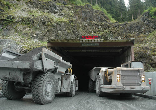 To trucks wait to enter a tunnel