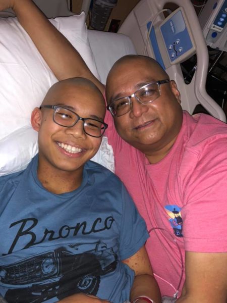 A boy with his father in a hospital bed