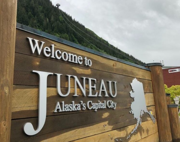 A wet wooden Welcome to Juneau sign