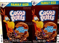 Two boxes of Cocoa Puffs, the one of the left smaller than the one on the right.