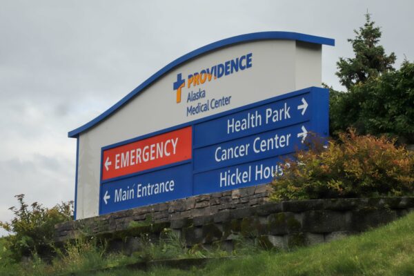an entrance sign to Providence Alaska Medical Center with arrows pointing to various buildings