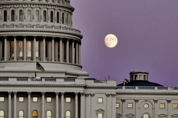 moonrise over Capitol, with dome to the left and purple sky.