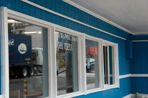 The outside of a restaurant, painted blue.