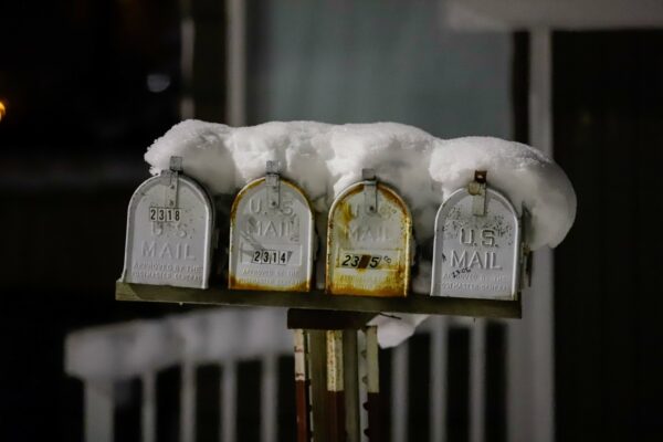mailboxes under snow at night