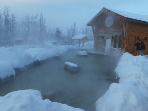 Steamy water surrounded by snow