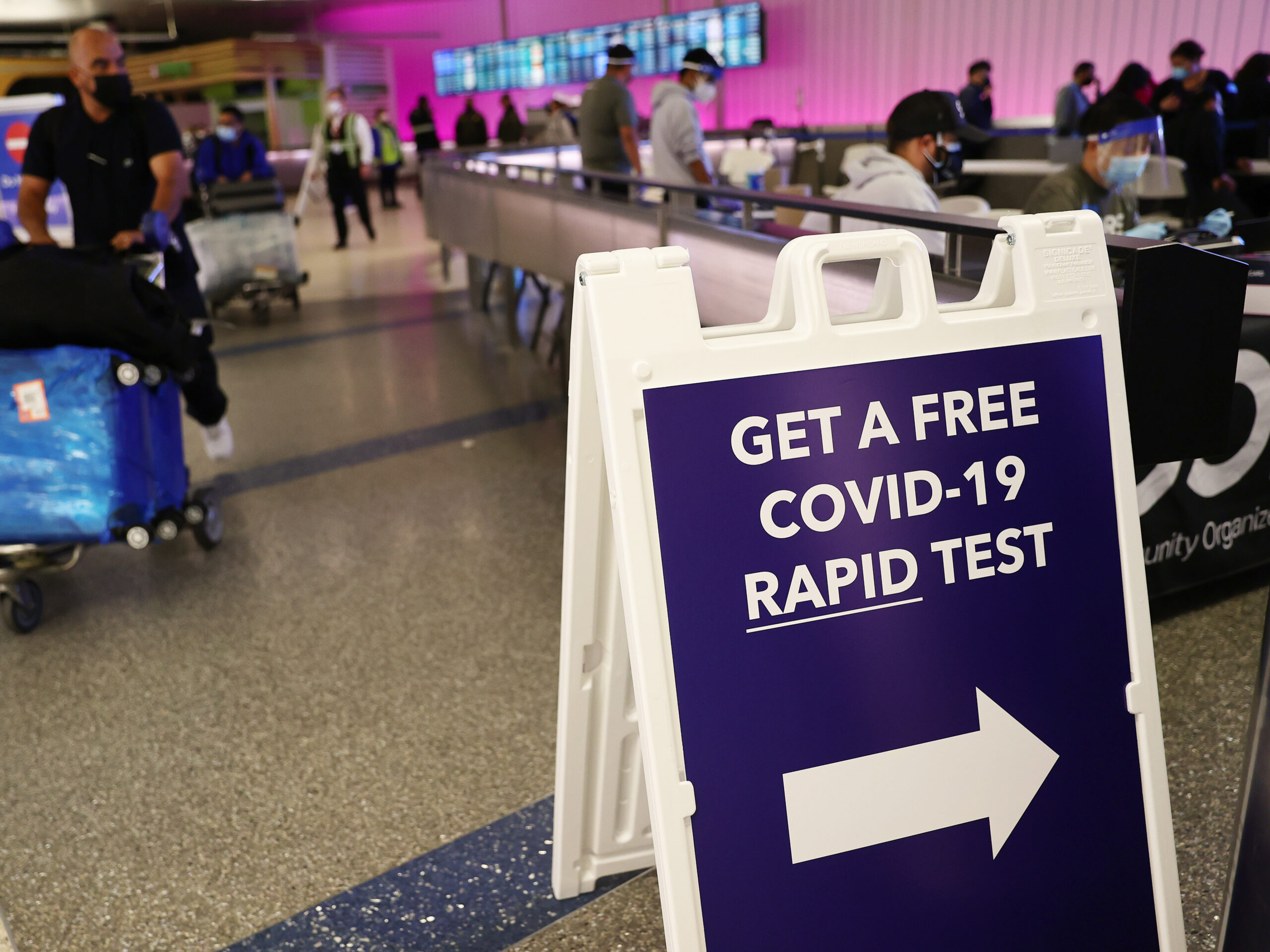 A sign in an airport for a free COVID-19 rapid test.