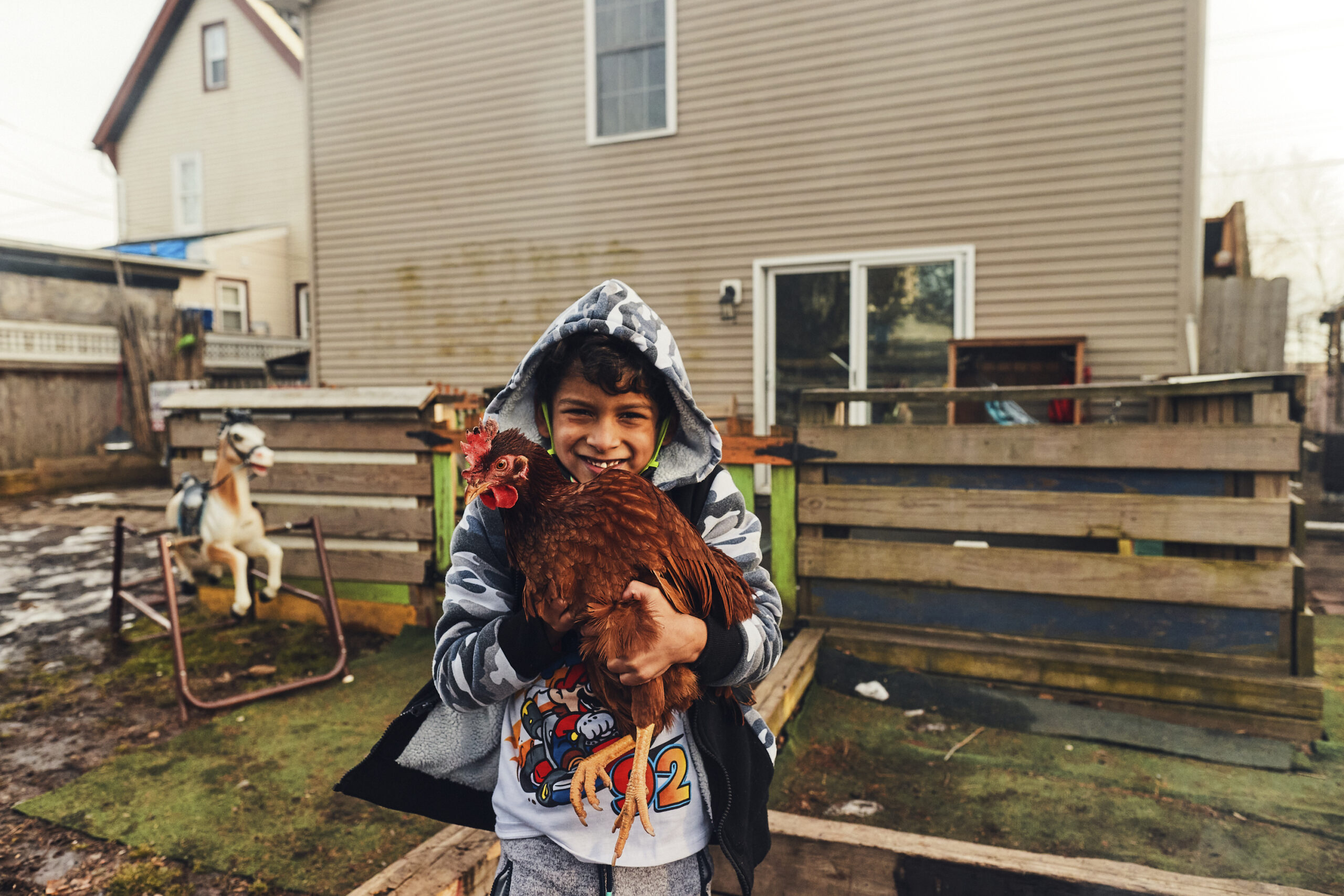 A child holds a chicken