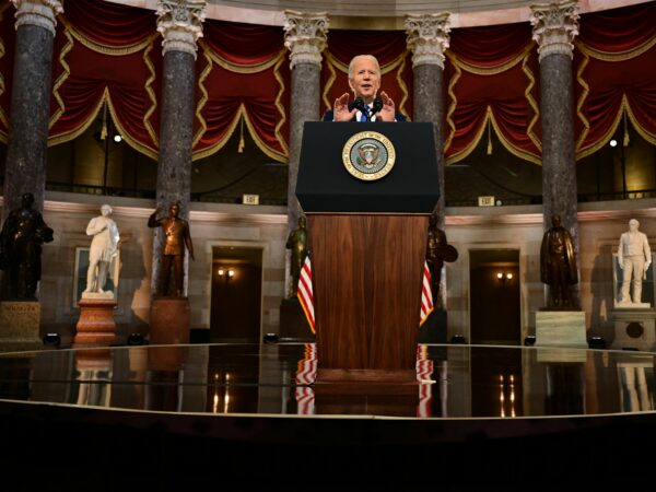 A man speaks at a podium.