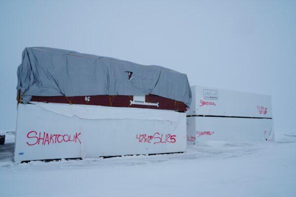 Shipping containers stacked up in the snow