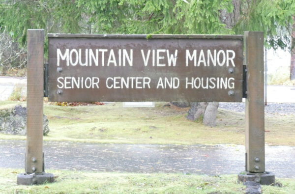 A wooden sign says Mountain View Manor